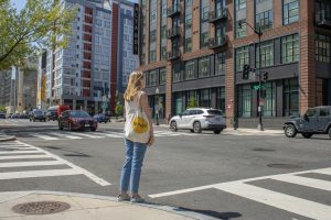 girl standing on a crossroad looking at Washington, D.C. real estate